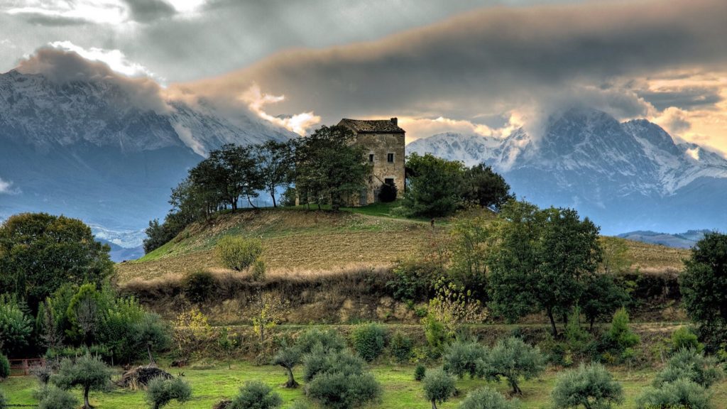 old-castle-on-a-hill-on-the-plain-before-the-mountains_2560x1440